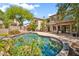 Lush backyard featuring a pool, covered patio, and mature landscaping, creating a serene outdoor living space at 3854 E Cathedral Rock Dr, Phoenix, AZ 85044