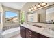 Bathroom features a large window, double vanity, and soaking tub at 3854 E Cathedral Rock Dr, Phoenix, AZ 85044