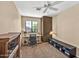 Bedroom featuring a ceiling fan, large window, wooden desk and black chair in a stylish home at 3854 E Cathedral Rock Dr, Phoenix, AZ 85044