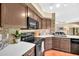 Well-lit kitchen features stainless steel appliances, stone backsplash, and ample cabinet space at 3854 E Cathedral Rock Dr, Phoenix, AZ 85044
