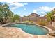 Inviting backyard swimming pool with a decorative waterfall feature and lush landscaping at 3854 E Cathedral Rock Dr, Phoenix, AZ 85044