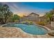 Backyard swimming pool surrounded by stone accents and desert landscaping at 3854 E Cathedral Rock Dr, Phoenix, AZ 85044
