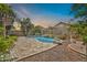 Backyard swimming pool with stone accents, desert landscaping, and a view of the house at 3854 E Cathedral Rock Dr, Phoenix, AZ 85044