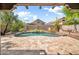 Inviting pool featuring a stone waterfall and a spacious travertine deck surrounded by lush landscaping at 3854 E Cathedral Rock Dr, Phoenix, AZ 85044