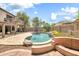 Backyard pool area with rock accents, lovely landscaping, and a raised patio with seating at 3854 E Cathedral Rock Dr, Phoenix, AZ 85044