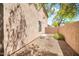 A side yard area features gravel, a wall, a small window, and some greenery at 3854 E Cathedral Rock Dr, Phoenix, AZ 85044
