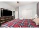Comfortable bedroom with a flatscreen television and ensuite bath at 40853 W Bravo Dr, Maricopa, AZ 85138