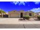 Charming single-story home with a two-car garage, desert landscaping, and neutral color palette at 40853 W Bravo Dr, Maricopa, AZ 85138