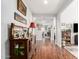 Spacious hallway with hardwood floors and decorative furniture leading to other rooms at 40853 W Bravo Dr, Maricopa, AZ 85138
