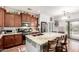 Contemporary kitchen with a granite island, stainless steel appliances, and hardwood floors at 40853 W Bravo Dr, Maricopa, AZ 85138