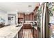 Well-lit kitchen featuring stainless steel appliances, granite countertops, and dark wood cabinetry at 40853 W Bravo Dr, Maricopa, AZ 85138