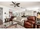 Open concept living room featuring hardwood floors, comfortable seating, and seamless flow at 40853 W Bravo Dr, Maricopa, AZ 85138