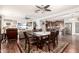 Spacious open-concept living space with dining area and kitchen visible, featuring hardwood flooring throughout at 40853 W Bravo Dr, Maricopa, AZ 85138