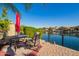 Cozy patio featuring a table and chairs with a lake view at 40853 W Bravo Dr, Maricopa, AZ 85138