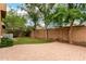 Lush backyard with low-maintenance turf, pavers and mature trees, surrounded by a privacy wall at 4368 E Cullumber St, Gilbert, AZ 85234
