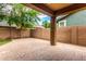 Inviting backyard featuring a covered patio and brick perimeter wall for added privacy at 4368 E Cullumber St, Gilbert, AZ 85234