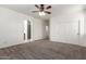 Spacious bedroom with neutral walls and carpeting, double door closet, and an adjacent bathroom at 4368 E Cullumber St, Gilbert, AZ 85234