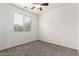 Well-lit bedroom with plush carpet, fan, and window offering ample natural light at 4368 E Cullumber St, Gilbert, AZ 85234