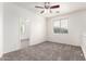 Bedroom has neutral walls and carpeting, a ceiling fan, and multiple windows with blinds at 4368 E Cullumber St, Gilbert, AZ 85234