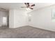 Bedroom with neutral walls and carpeting, a ceiling fan, and double-door closet at 4368 E Cullumber St, Gilbert, AZ 85234