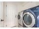 Functional laundry room equipped with modern washer and dryer units next to the door at 4368 E Cullumber St, Gilbert, AZ 85234