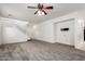 Open-concept living area with plush carpet, neutral walls, and a view of the front entry at 4368 E Cullumber St, Gilbert, AZ 85234