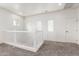 Bright open loft area with neutral carpet, natural light, and white staircase railing at 4368 E Cullumber St, Gilbert, AZ 85234