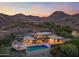 Aerial view of modern home featuring an infinity pool and stunning mountain views at 4536 E Foothill Dr, Paradise Valley, AZ 85253