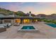 Beautiful backyard with pool, spa and outdoor seating with mountain views at dusk at 4536 E Foothill Dr, Paradise Valley, AZ 85253