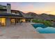 Backyard with a covered outdoor dining area, a modern pool, and mountain views at 4536 E Foothill Dr, Paradise Valley, AZ 85253