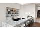 Stylish bar with marble countertops, open shelving, and seating for entertaining guests at 4536 E Foothill Dr, Paradise Valley, AZ 85253
