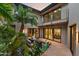 Private courtyard with comfortable outdoor seating and lush tropical plants, creating a serene retreat at 4536 E Foothill Dr, Paradise Valley, AZ 85253