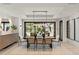 Dining room with modern lighting, seating for eight, and sliding glass doors to an outdoor patio at 4536 E Foothill Dr, Paradise Valley, AZ 85253