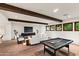 Large game room with a pool table, comfortable seating area, hardwood floors, and exposed beams at 4536 E Foothill Dr, Paradise Valley, AZ 85253