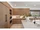 Kitchen showcasing custom cabinetry, built-in appliances, a large island with bar seating, and mountain views at 4536 E Foothill Dr, Paradise Valley, AZ 85253