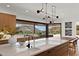 Modern kitchen featuring an island, sleek cabinets, and a window with views of the desert landscape at 4536 E Foothill Dr, Paradise Valley, AZ 85253