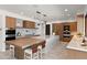Modern kitchen with a large island, stone countertops, seating, stainless steel appliances, and custom lighting at 4536 E Foothill Dr, Paradise Valley, AZ 85253