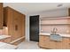Well-lit laundry room boasts custom cabinets, stainless steel sink, modern fixtures, and neutral tile flooring at 4536 E Foothill Dr, Paradise Valley, AZ 85253
