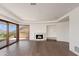 Spacious living room with marble fireplace, hardwood floors, and a large sliding door to the outdoor patio at 4536 E Foothill Dr, Paradise Valley, AZ 85253