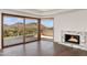 Bright living room with a marble fireplace and floor-to-ceiling windows showcasing a breathtaking mountain view at 4536 E Foothill Dr, Paradise Valley, AZ 85253