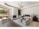 Bright main bedroom boasts a fireplace and a sliding glass door leading to an outdoor lounge area at 4536 E Foothill Dr, Paradise Valley, AZ 85253