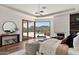 Comfortable main bedroom features wood floors, an eye-catching light fixture, and mountain views at 4536 E Foothill Dr, Paradise Valley, AZ 85253