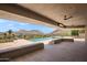 Outdoor living space with a pool, patio seating, ceiling fans, a built-in lounge, and mountain views at 4536 E Foothill Dr, Paradise Valley, AZ 85253