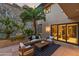 Patio with comfortable seating area, a decorative rock wall feature, and access to the home's interior spaces at 4536 E Foothill Dr, Paradise Valley, AZ 85253