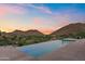 Gorgeous pool overlooking mountains with a serene desert sunset in the background at 4536 E Foothill Dr, Paradise Valley, AZ 85253