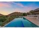 Infinity pool with a stunning view of mountains, and luxurious seating areas in the backyard at 4536 E Foothill Dr, Paradise Valley, AZ 85253