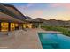 Beautiful infinity pool with scenic view of the mountains at dusk at 4536 E Foothill Dr, Paradise Valley, AZ 85253