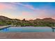 Infinity edge pool with glass fencing has unobstructed desert and mountain views at 4536 E Foothill Dr, Paradise Valley, AZ 85253
