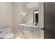 Elegant powder room featuring marble vanity, modern faucet, and wall-mounted lighting. Tasteful finishes enhance the space at 4536 E Foothill Dr, Paradise Valley, AZ 85253