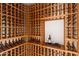 Custom wine cellar with wooden racks and a display shelf showcasing wine bottles and glasses at 4536 E Foothill Dr, Paradise Valley, AZ 85253